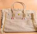Detalle pompones y borlas bolso tote boho beige crema artesanal | vaqueraspain